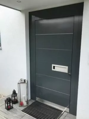 Graualuminium-Tür mit breitem Rahmen und metallischer Unterkante.